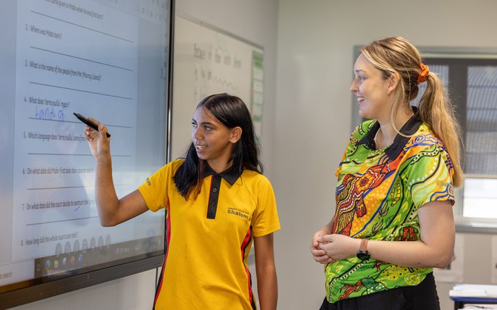 Carinity Education Shalom teacher Laura Peleseuma assisting a student at the Townsville school
